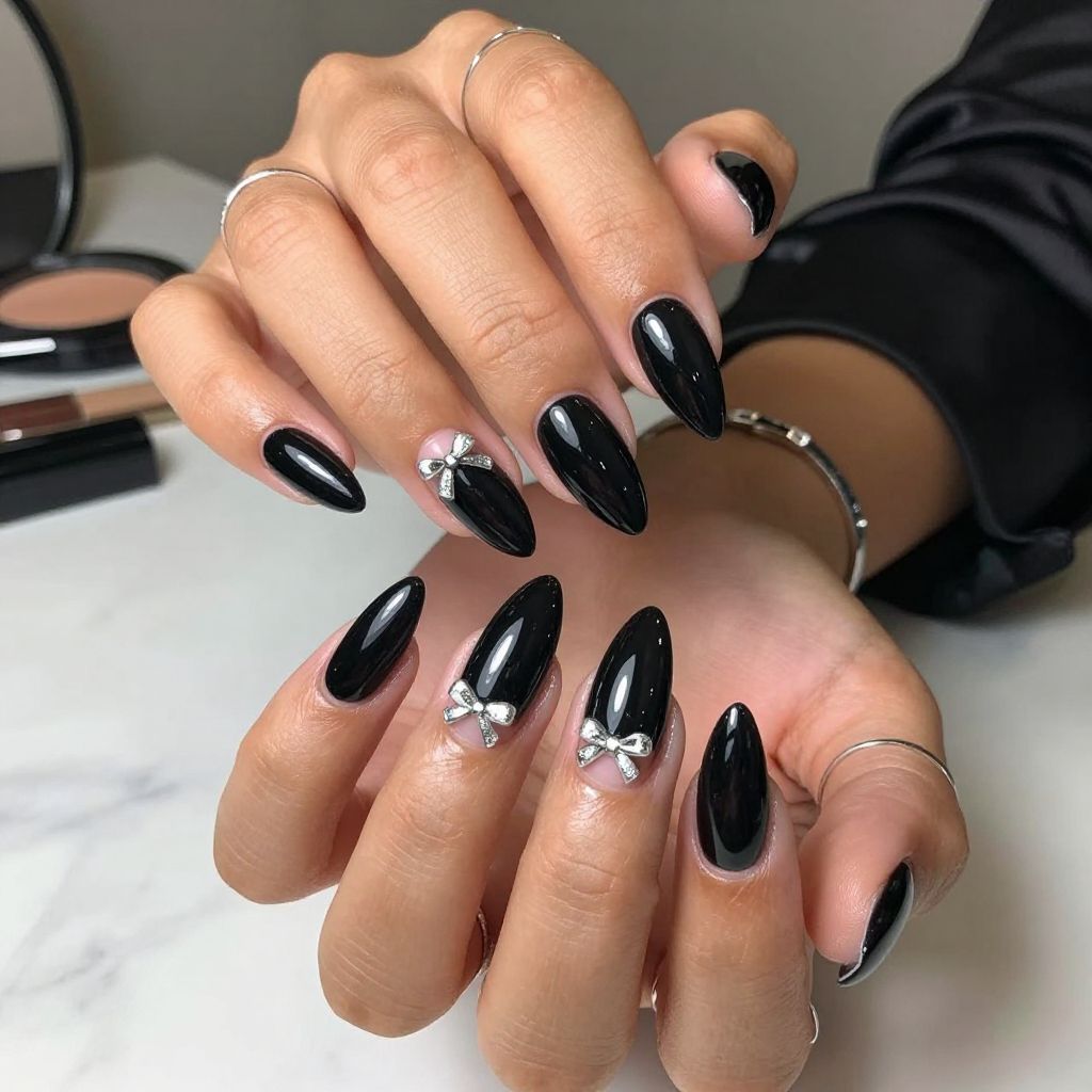 Glossy Black Nails with Metallic Silver Bows
